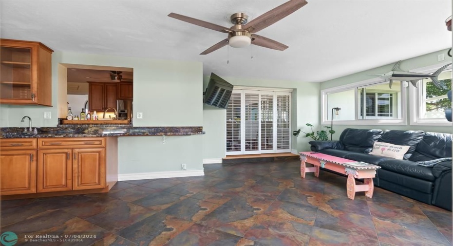 Florida room wet bar and pass through to the kitchen (and more formal dining area behind the Plantation shutters) for easy entertaining!