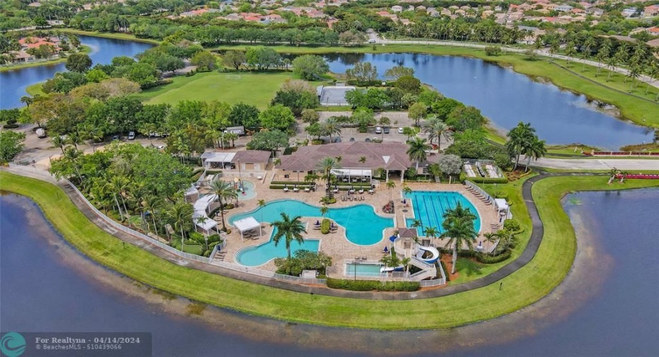 Aerial view of the clubhouse that includes fabulous amenities such as the community pools, basketball courts, hockey field, playgrounds, mini-golf, and café