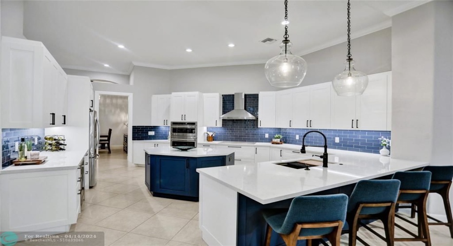 Newly remodeled large gourmet chef's kitchen. High end stainless steel appliances, quartz countertops, dual toned, under mount lighting. Impeccable condition
