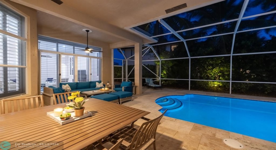 Enjoy balmy evenings under the generous covered patio, with new travertine pool deck, newly refinished heated pool with colored lights, new pool equipment, screened for year-round comfort.