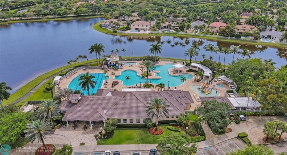 Aerial view of the clubhouse that includes fabulous amenities such as the community pools, basketball courts, hockey field, soccer field, playgrounds, mini-golf, and café.