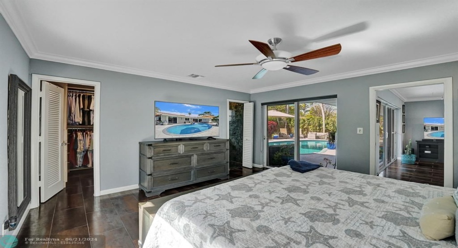 Primary bedroom located in the back of the home over looking your pool area.