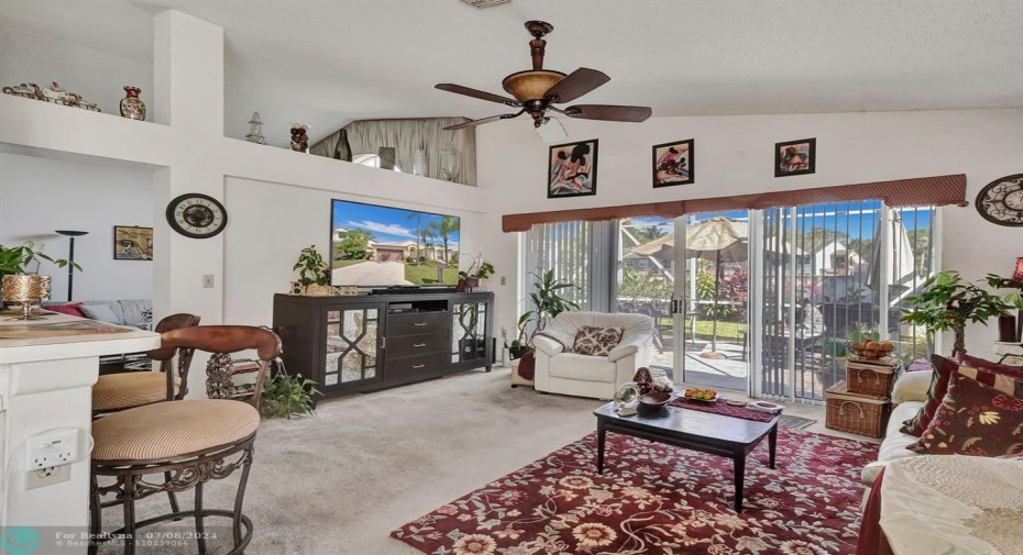 This area provides ample seating for everyone to sprawl out with a movie night or enjoy quality time together. Natural light streams in through the sliding doors, creating a bright and cheerful atmosphere that’s perfect for playing games or reading stories.