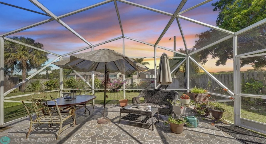 Imagine extending your living space to this expansive screened-in patio and creating your own private oasis for entertaining!  Slide open the easy-access glass doors and step into a world of sunshine and fresh air. This sheltered haven is perfect for hosting unforgettable gatherings for family and friends.