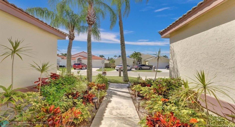 Unwind and step into serenity as you open the front door of 4969 Broadstone Circle. Lush green palms swaying gently in the breeze flank the entrance, casting dappled light and creating a calming welcome.