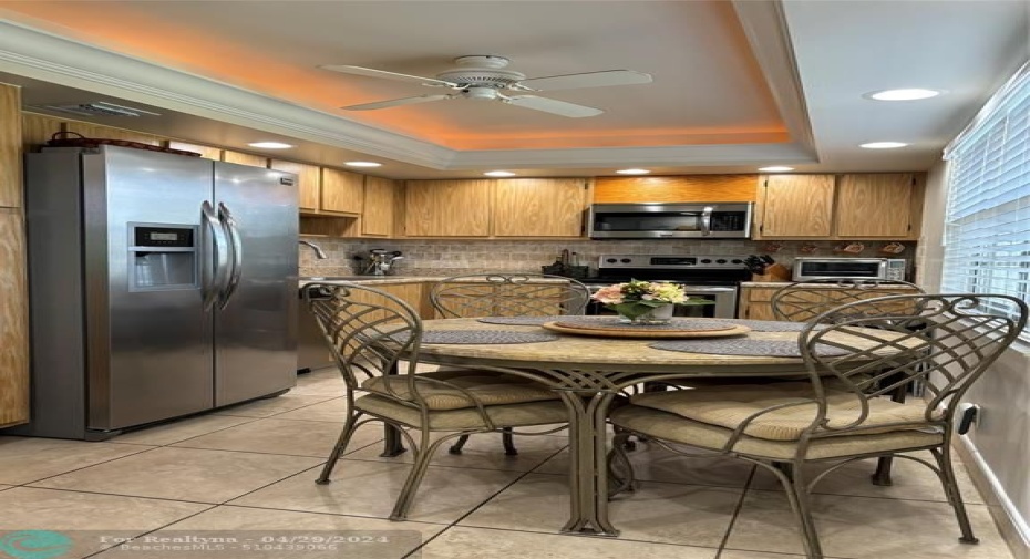 The kitchen with tray ceiling with recessed lighting is a chef's delight!