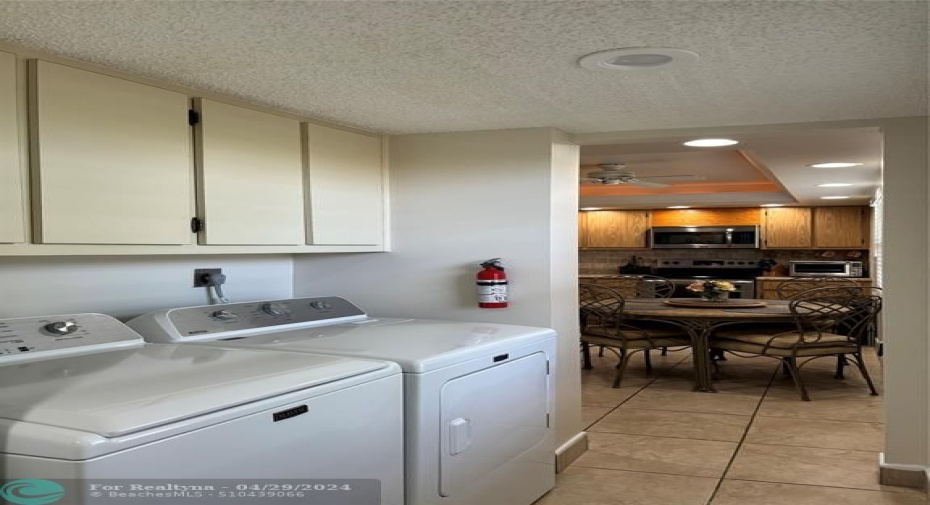 The laundry has additional cabinets and great natural light.