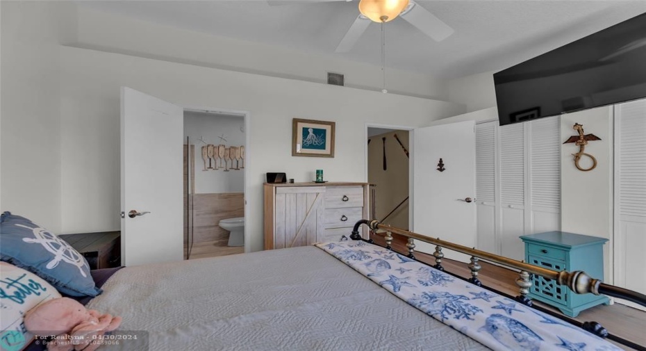 Master bedroom and bathroom with an abundance of closet space