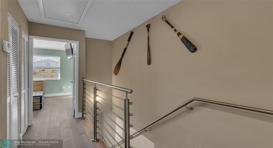 Open staircase on second level and offers closet space in walkway between bedrooms