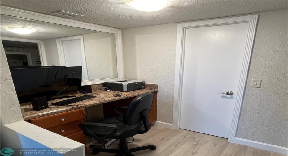 Desk/workspace in master bedroom; door in view leads to walk-in closet