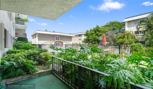 Private porch with lush foliage opposite pool area