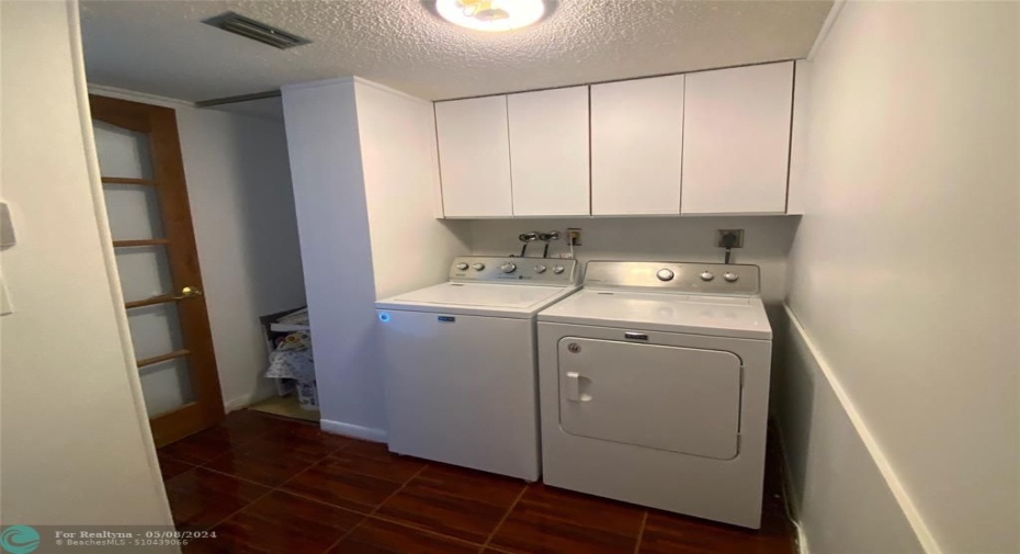 Laundry room with full-sized washer and dryer.