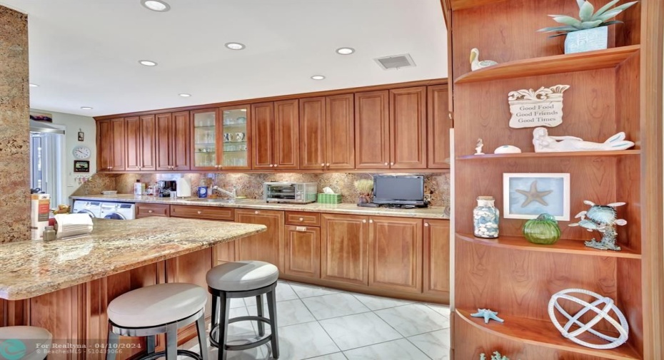The Kitchen features Granite countertops with an eat-at bar, stainless steel appliances, ample storage space.