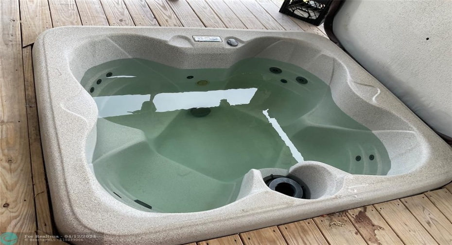 4-seat hot tub on rear covered porch
