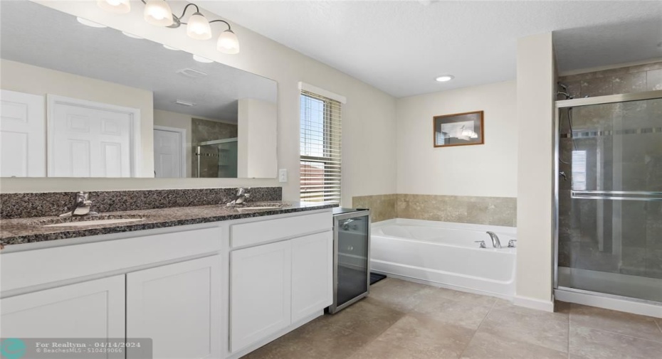 Dual sinks, separate water closet with door.