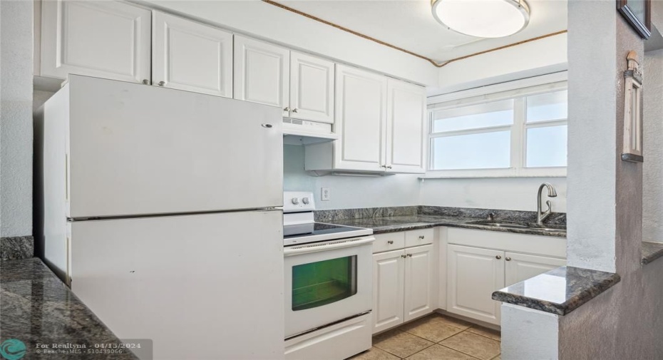 Bright kitchen that opens to your living room with a brand new range hood and oven that has never been used.