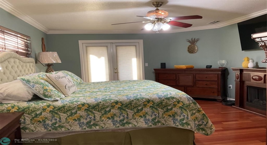 Master bedroom with French doors out to hot tub and lanai