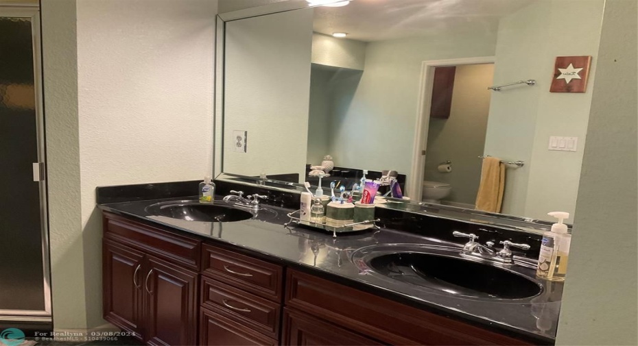 Master bathroom with double sinks and cultured marble countertops