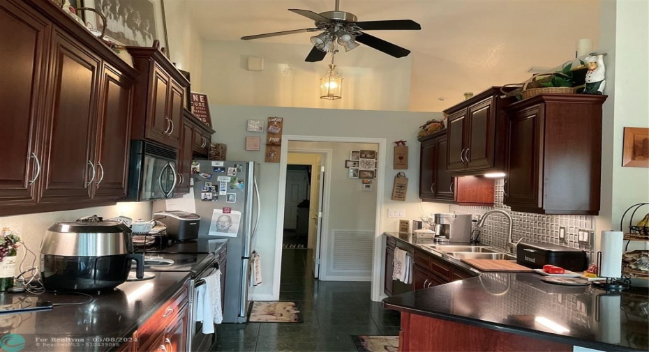 Kitchen with cherry cabinets and quartz countertops