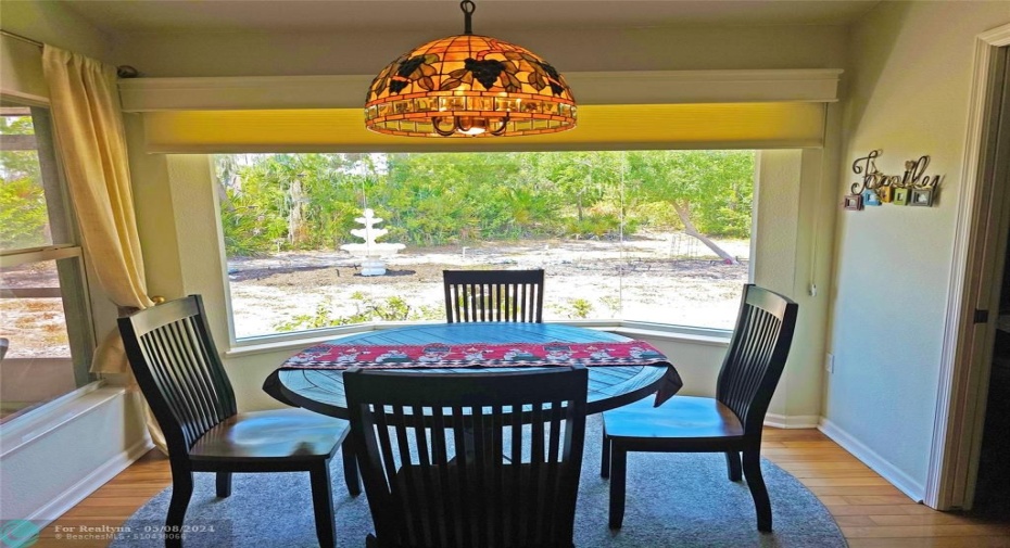 Breakfast nook off kitchen with beautiful windows overlooking fountain and garden area