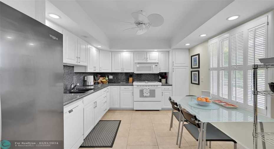 Lots of light pours into this Eat-in Kitchen with granite counters