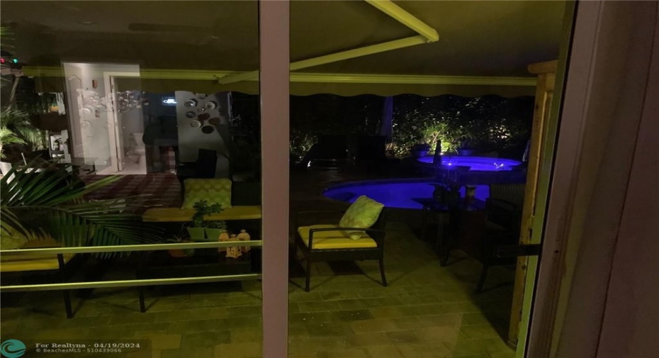 POOL AREA SEEN FROM MASTER BEDROOM AT NIGHT
