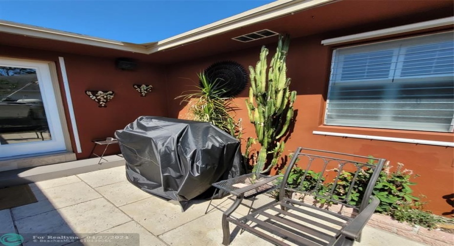 Patio with pre-cast stone tile, wired for speaker hook-up outside for entertaining (BBQ grill conveys)