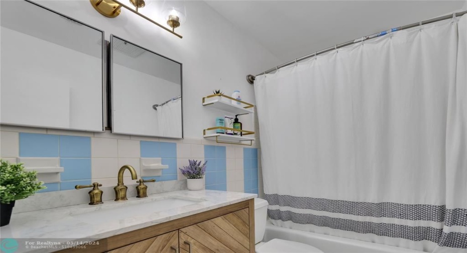 New Vanity, faucet lighting and showerheads for this beach vibes bathroom.
