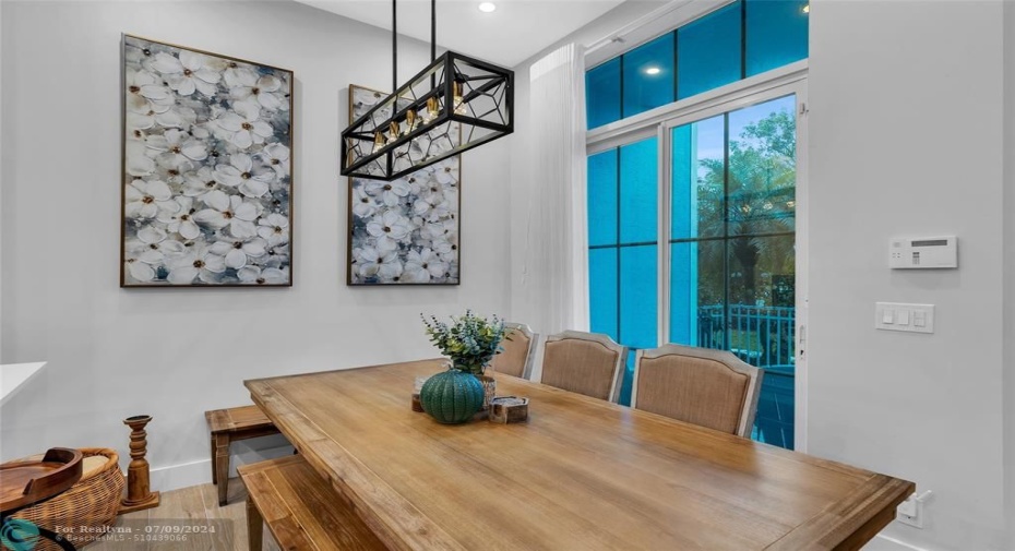 Dining room is open and spacious with designer and recessed lighting and great natural light