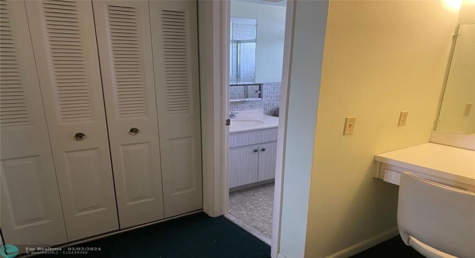 Dressing area outside master bath with tub and shower