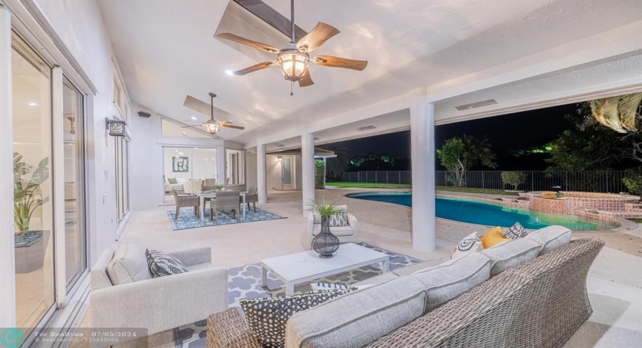 Huge covered patio makes for amazing an indoor-outdoor lifestyle! Two ceiling fans and expansive lawn for play!