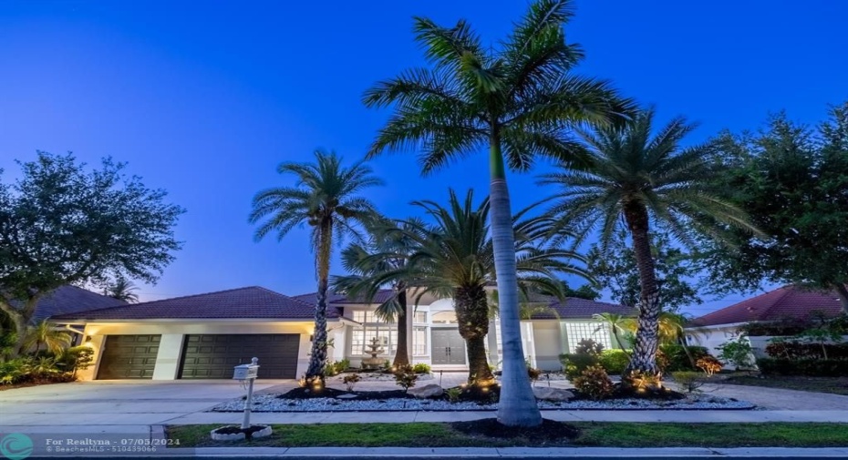Wide circular driveway, huge island dotted with uplighting, soaring palm trees, 3CG and a stunning single story luxury home awaits you!
