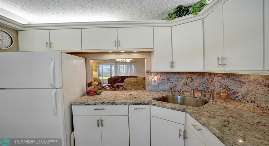 Updated Kitchen with Custom Cabinets/Granite Counters SSL Deep Sink, filtered Drinking Water Spout, Dish Liquid Dispensor, Diposal. Under and Over Cabinets Lighting.