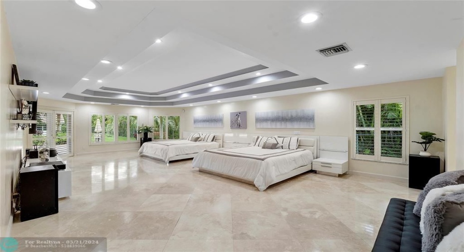 PRIMARY BEDROOM APPROX 17 X 30 SQ FT-TRAY CEILING WITH MOOD LIGHTING-FRENCH DOORS OVER LOOKING POOL-MARBLE FLOORS