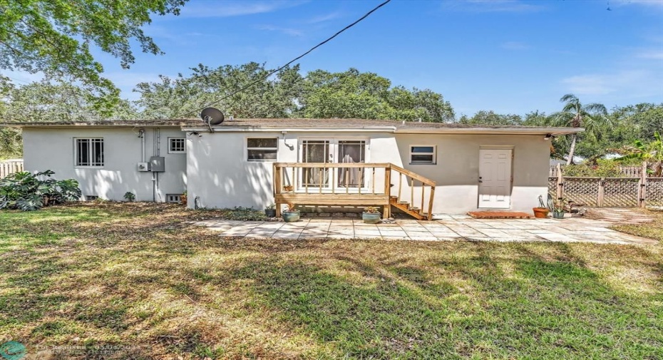 Back View of the Home with door into Garage on the right.