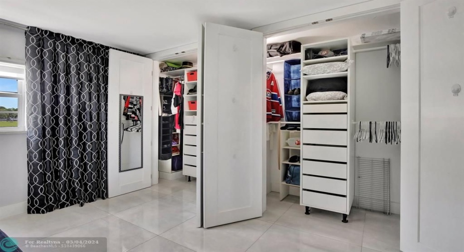 Master bedroom custom closet with cabinets