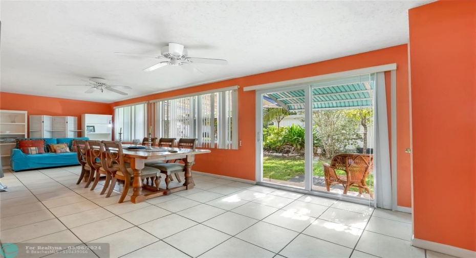 The spacious Florida room, flooded with natural light, offers a versatile and inviting space for various activities