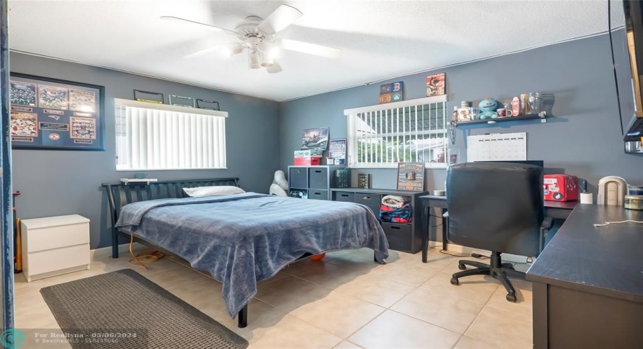 Spacious and inviting, the second bedroom boasts ample room for a bed, a cozy sitting area, and a functional workstation, offering both comfort and versatility