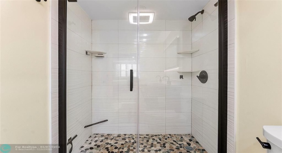 Frameless Shower with Pebble Floor