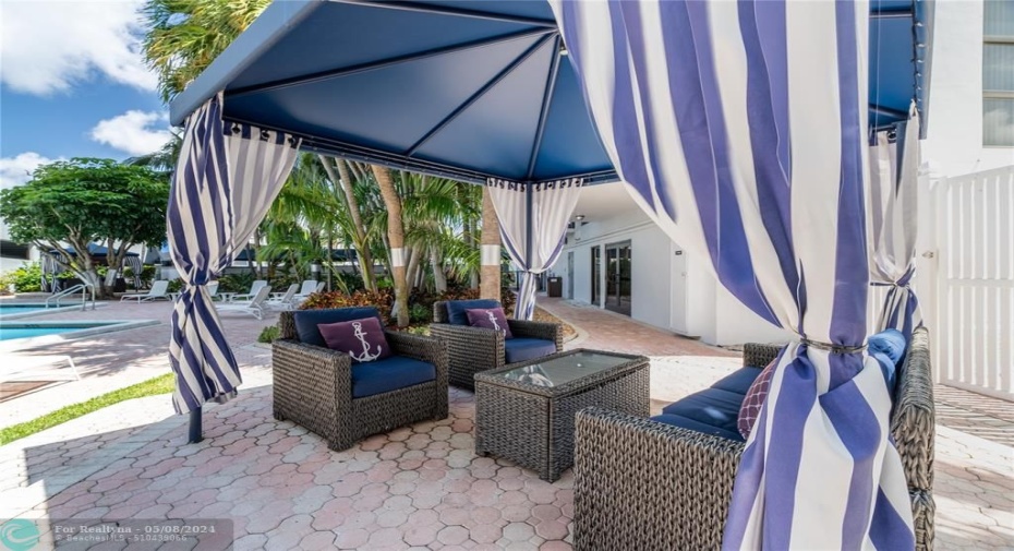 Covered patio area with comfortable seating