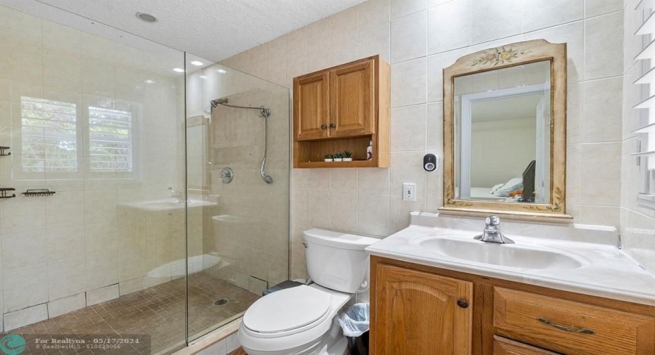 Primary bathroom suite with mosaic tile and frameless shower doors!
