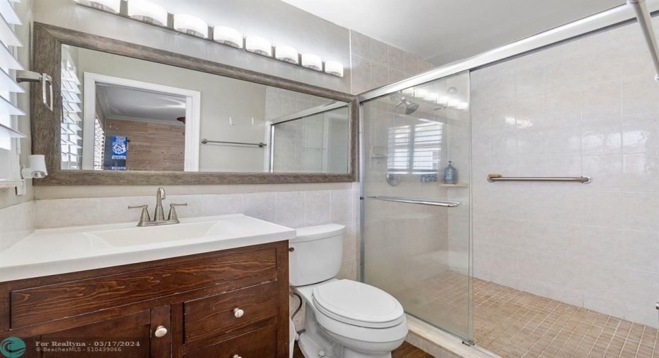 Updated guest bathroom features frameless shower doors!