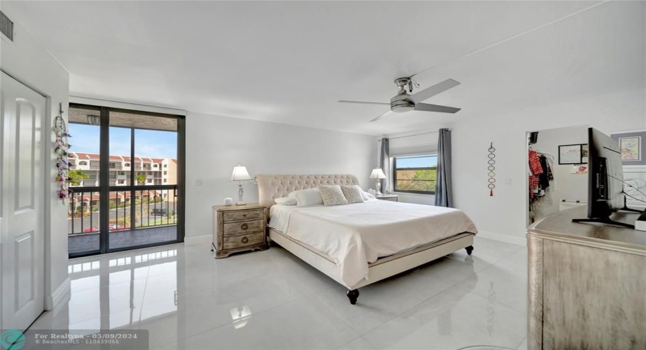 Spacious Master Bedroom with Patio Doors To Private Screened Balcony