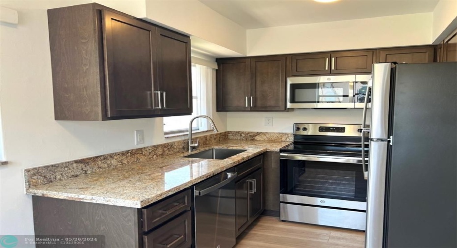 Newly remodeled Windowed Kitchen with Stainless Steel Appliances and Solid wood Cabinets and Granite Counters