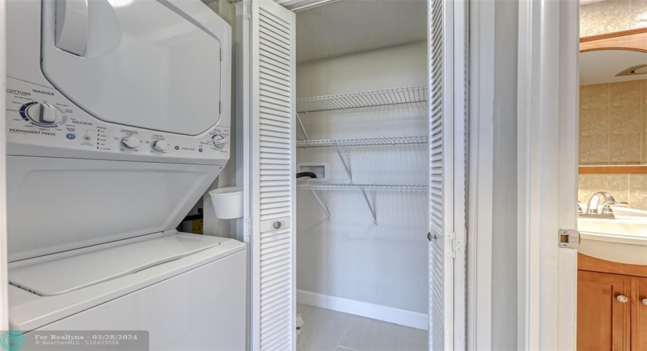 Washer and dryer and walk in closet located in second bedroom suite