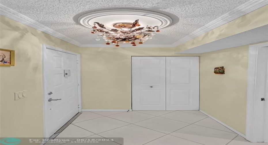 Custom chandeliers throughout, laundry room is the closed door in center