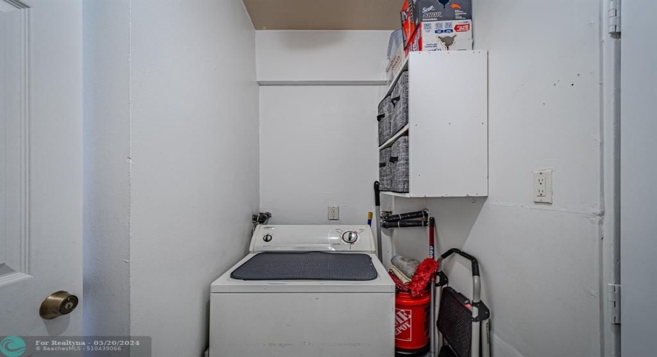 Laundry room with washer and dryer on the other side shelves for extra storage