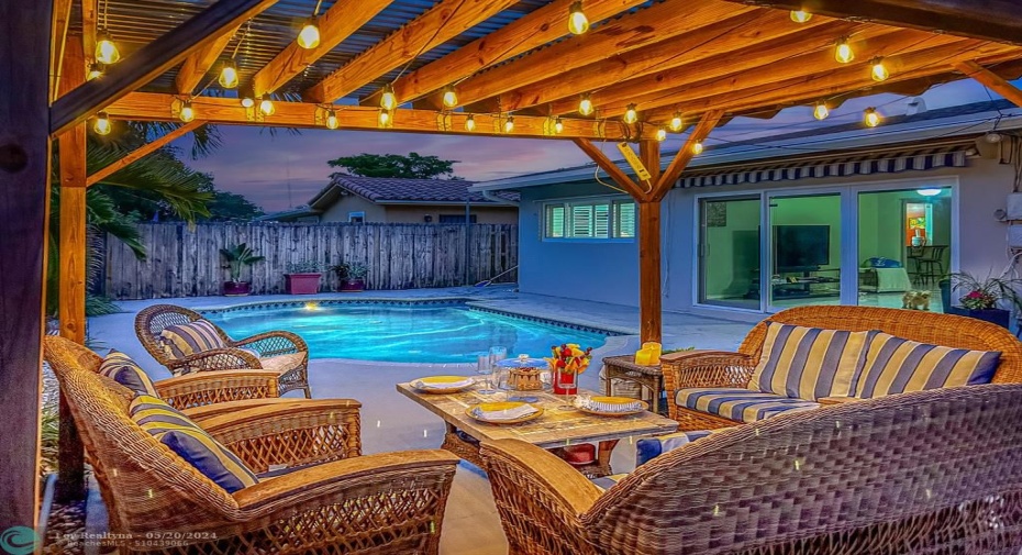 Enjoy a tranquil pool backyard, with covered seating under pergola, retractable sun shade, barbeque and nice landscaping.
