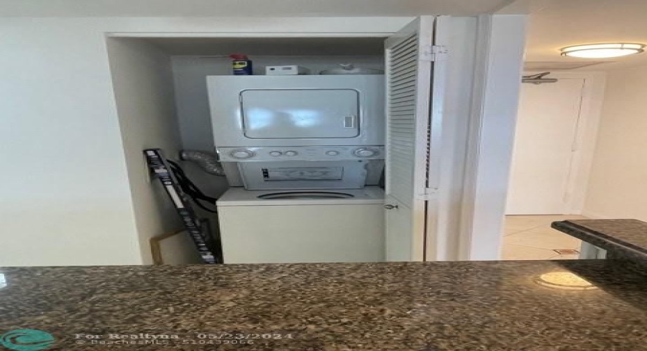 The washer and dryer are located in the kitchen.