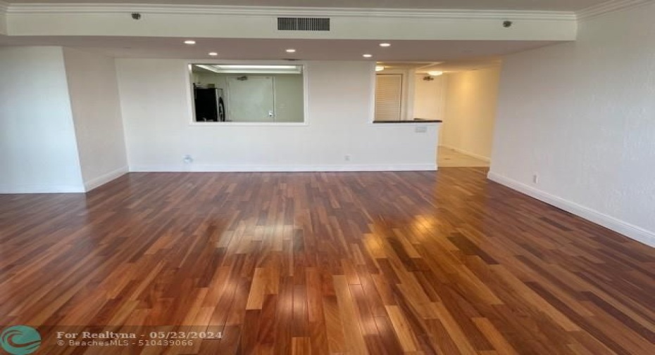 With your back to the windows and the balcony, facing towards the kitchen. The hallway to the right leads out to the front entrance.The main living areas and both bedrooms have beautiful wood floors. The apartment is newly repainted. The apartment was just professionally cleaned.